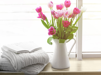 Beautiful fresh tulips on windowsill background