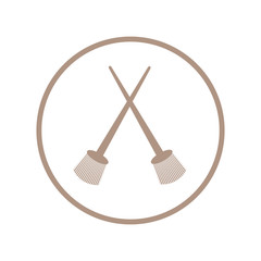 Stylized icon of a two colored crossed paint brushes in a circle