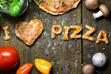 dough letters and vegetables on rustic wooden table, text i love