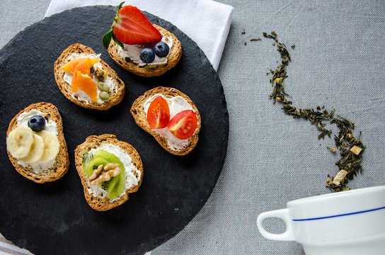 Presentation of various snacks with an artistic cup of tea