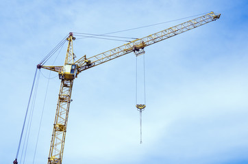 Fototapeta na wymiar Tower crane on the sky background