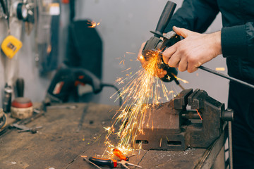 Metal worker using grinder.