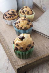 Muffins with chocolate on a wooden table