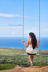 Sea landscape with a girl on swing