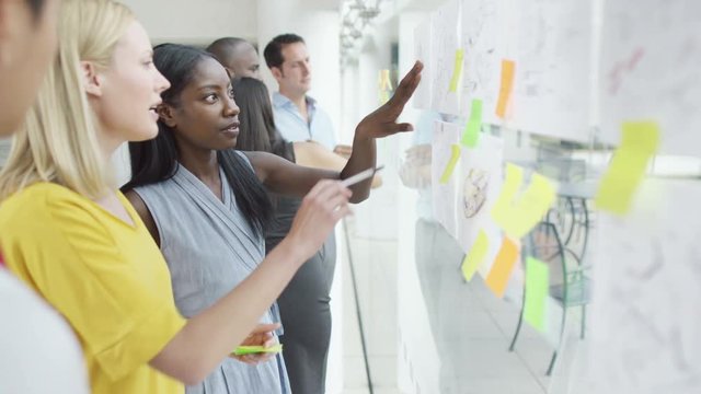  Creative design business team brainstorming for ideas with sticky notes