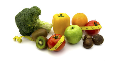 Group of various fruits with measuring tape over white backgroun