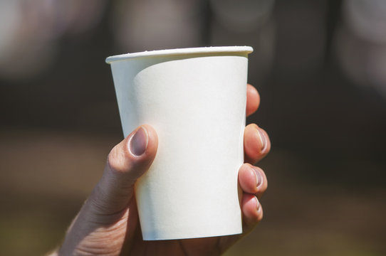 Hand Holding A Paper Cup With Soda, Tea, Coffee Or Another Beverage