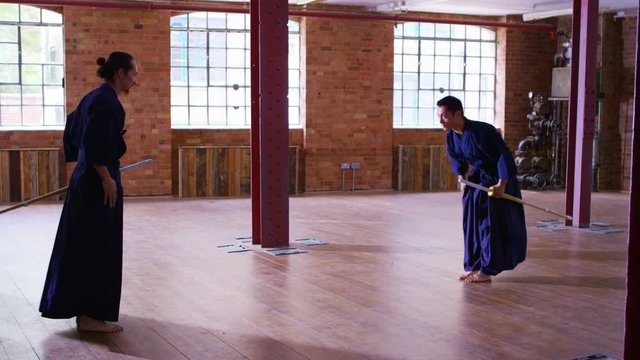  Japanese kendo fighters training together with bamboo swords