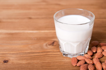 glass of almond milk and almond close