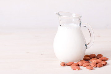 glass of almond milk and almond close