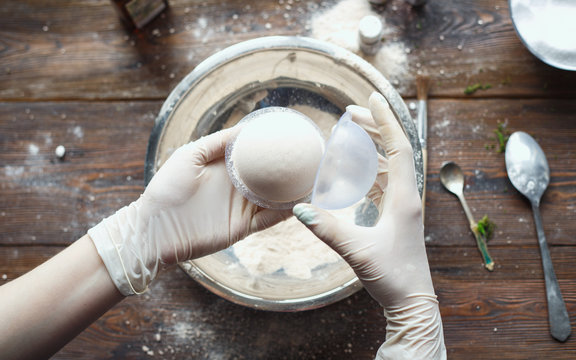 Preparation of bath bombs. Ingredients and floral decor on a wooden vintage table.