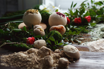 Preparation of bath bombs. Ingredients and floral decor on a wooden vintage table.