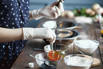 Preparation of bath bombs. Ingredients and floral decor on a wooden vintage table.