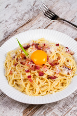 Carbonara pasta with raw egg, bacon and parmesan cheese