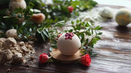 Obraz na płótnie Canvas Preparation of bath bombs. Ingredients and floral decor on a wooden vintage table.
