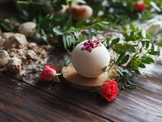 Preparation of bath bombs. Ingredients and floral decor on a wooden vintage table.