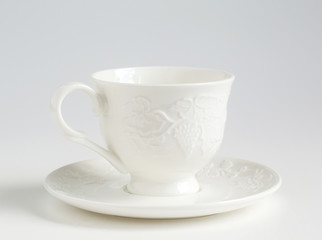 white cup and saucer