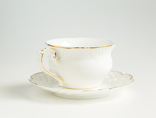 white cup and saucer