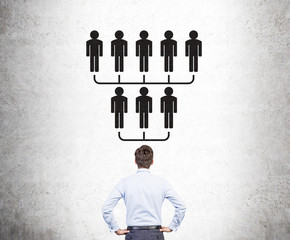 Businessman looking at hierarchy sketch