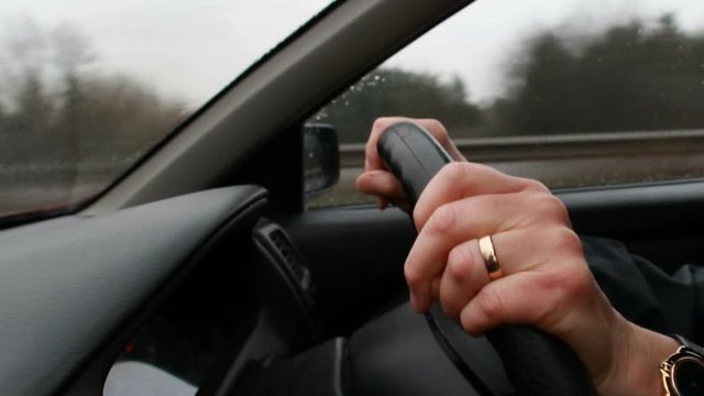 Married woman driving (close up hands)