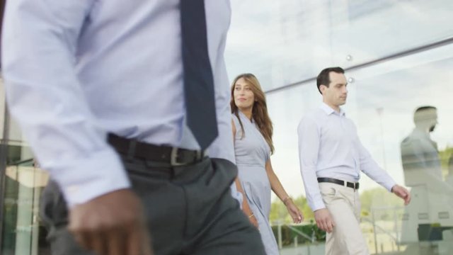 Confident female business team walking together outside office building
