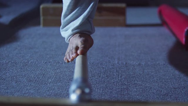  Feet Of Unrecognizable Male Gymnast Training On Practice Beam At The Gym