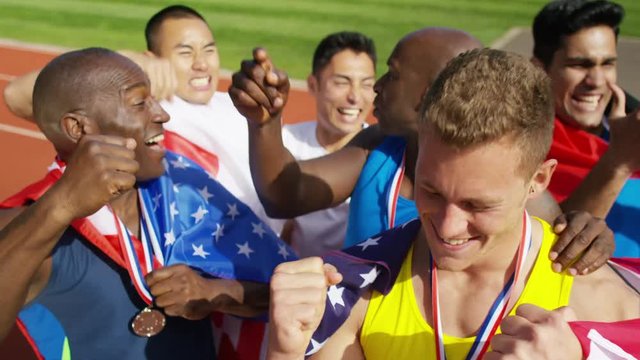  Group of athletes (disabled & able bodied) celebrate victory on running track