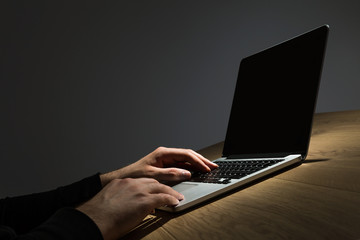 Male hands hacking laptop