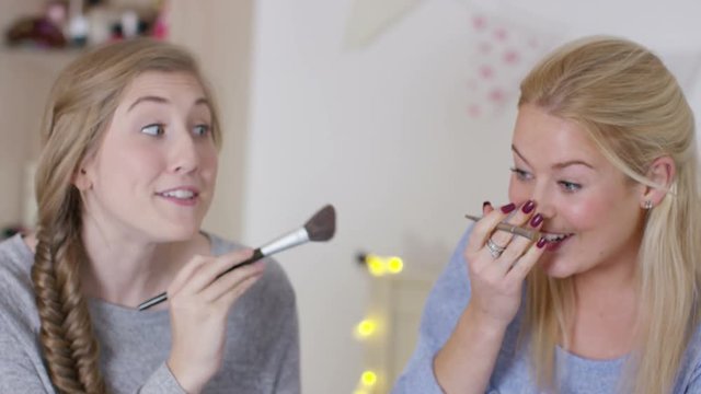  Teenage girls hanging out in bedroom, putting on make up & chatting
