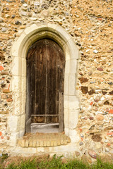 Fototapeta na wymiar Old Wooden Church Door and Stone