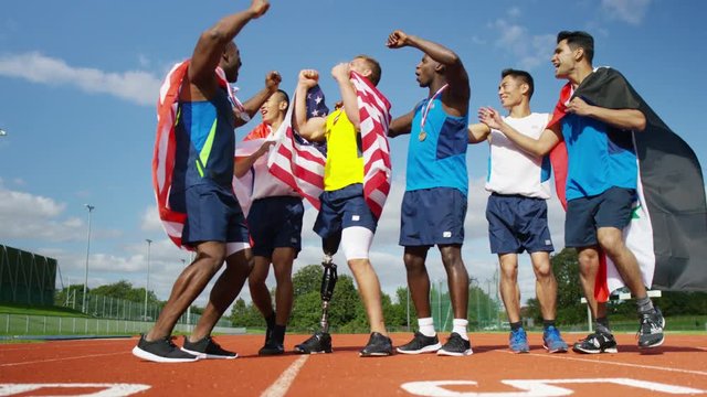  Group of athletes (disabled & able bodied) celebrate victory on running track