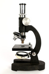 A vintage student microscope isolated on a white background