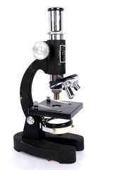 Side view of a vintage microscope on a white background
