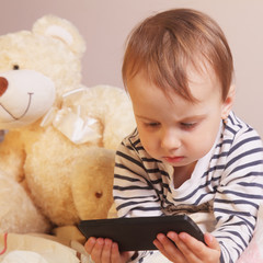 Little beautiful  girl with smart phone on the background of Bea