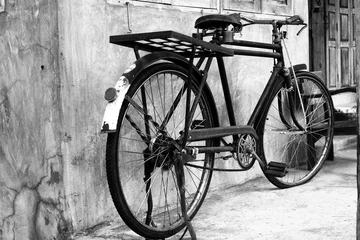 Fotobehang Black and white photo of vintage bicycle - film grain filter effect styles © jakkapan