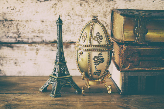 image of feberge egg, decorative eiffel tower and vintage books