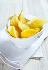 Wedges of Fresh Lemon in White Bowl on Table