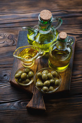Still life with olive oil and green olives, studio shot, closeup