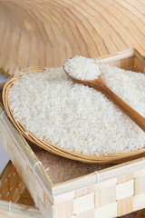 Raw and uncooked rice in wooden spoon,shallow Depth of Field,Focus on rice. 