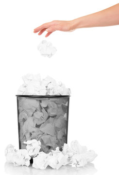 Hand throwing crumpled paper into office trash isolated on white 