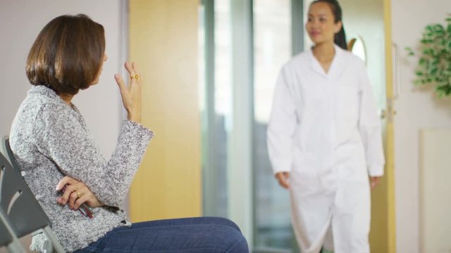  Worried woman sits alone in hospital waiting area 