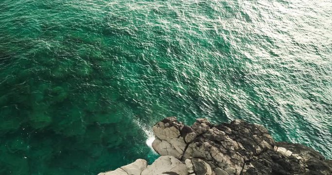 Aerial view cliff jumping into ocean, summer lifestyle fun