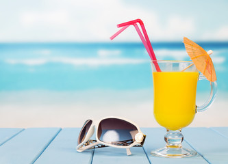 On the table there was a glass of orange juice 