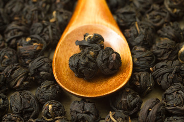 Fototapeta na wymiar Chinese black tea leaf balls inside wooden spoon