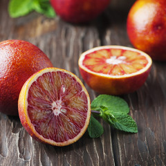 Red sweet bloody oranges on the wooden table