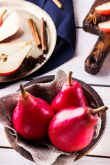 Red pears  in ceramic bowl .