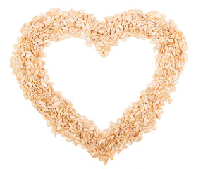 Frame in the form of  heart sunflower seeds isolated on white 