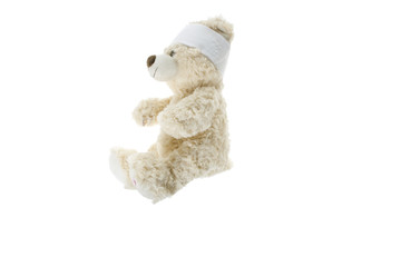 injured teddy  bear with bandage
