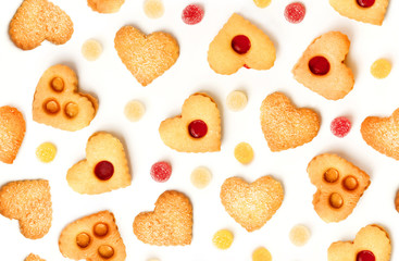 Seamless background pattern with heart-shaped tea cookies and gum drops on white