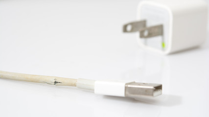 Closeup the Broken Charger Cable on white background